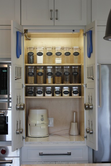 Organized Baking Station with Nutrimill, Tribest Personal Blender, a variety of whole grains, and baking supplies and utensils