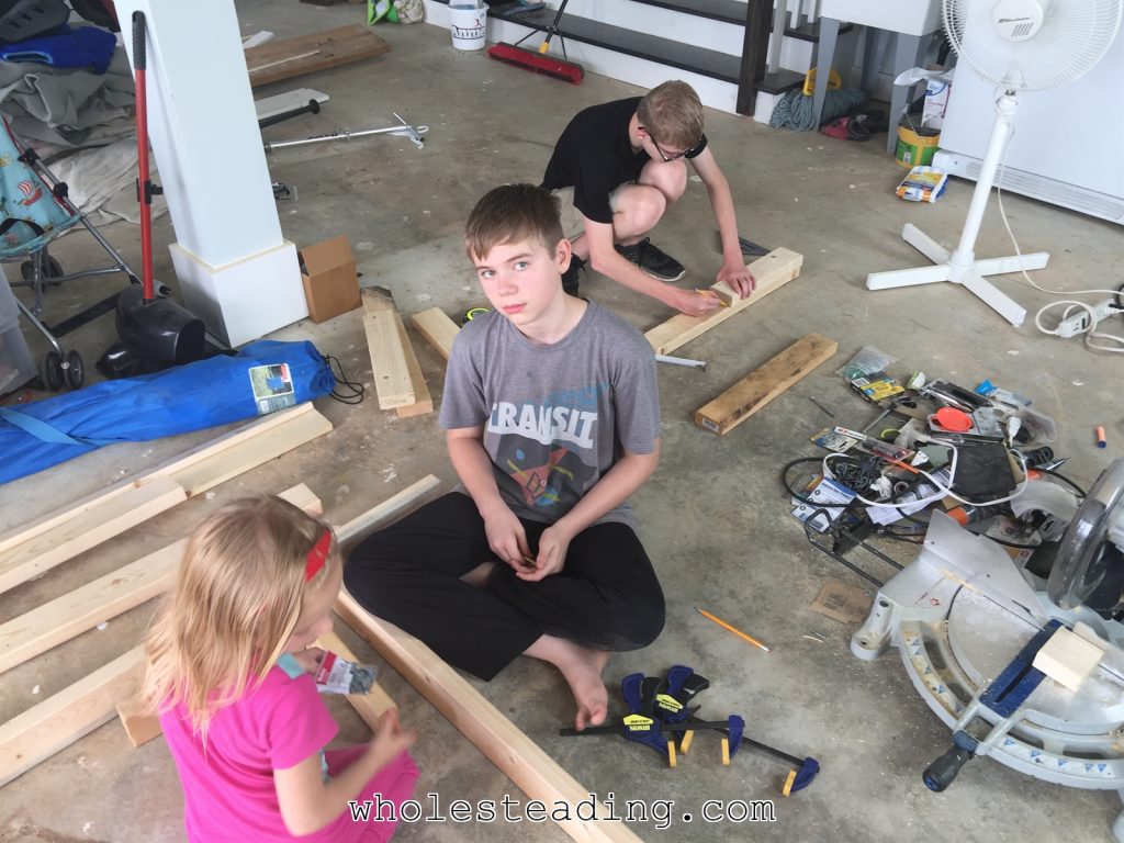 The kids helped with almost every step. Canaan is measuring and making the cuts and Harvest and Noble are putting the washers on the screws and starting them in the pilot holes